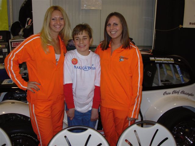 Make a Wish boy Christopher flanked by the Hooters Girls....
...talk about a wish come true!
