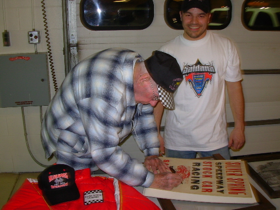 Jack Frasier signs Rocky Magaro's old Silver Spring poster.
