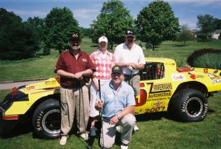 The fun foursome at Heritage Hills
The Wise Guy, Marian (Rose) from CBS TV-21, Jeff Walter from Zimmerman's Automotive and kneeling driver Gary Johnston at a Clear Channel Outing May 2006
